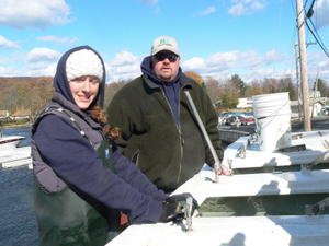 Amy & Craig unloading the hatchery truck to the waiting Muskies inc members